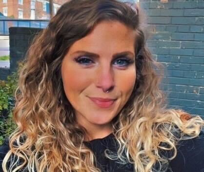 brewer A young white woman with blonde curly hair