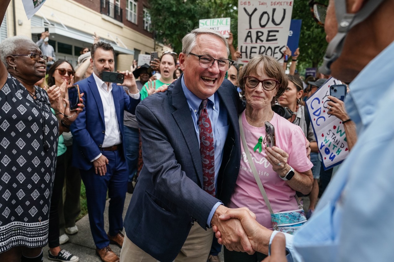 Dan Jernigan shakes the hand of a man off screen outside of the CDC headquarters.
