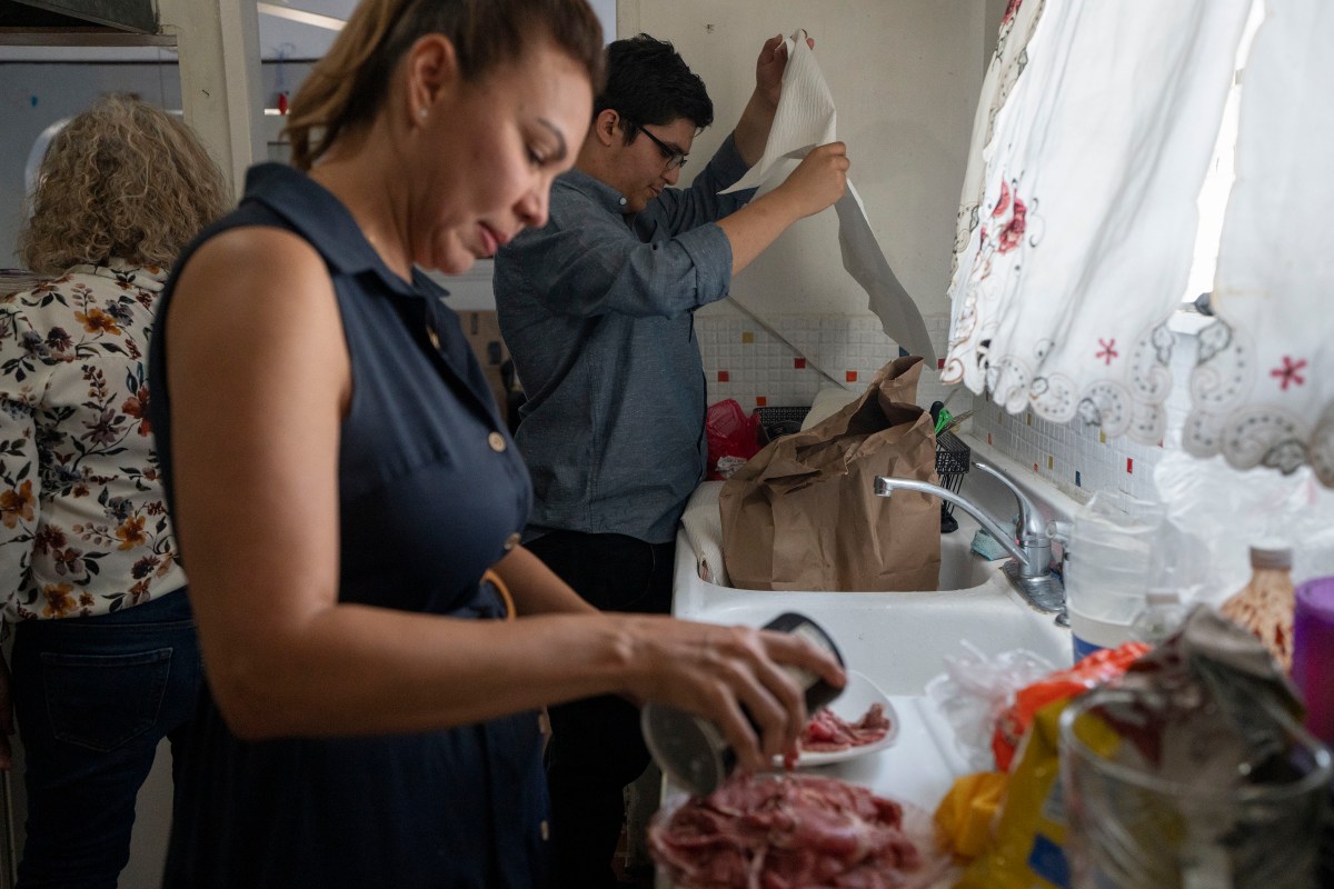 growing-up-scared-mental-health-09-web A man and woman stand in front of a sink and an open window as they prepare food in a kitchen