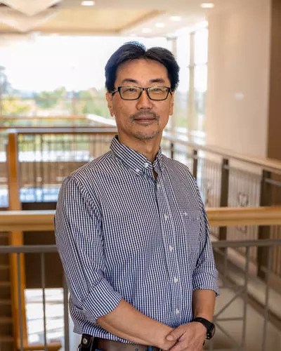 A headshot of James Mu indoors.