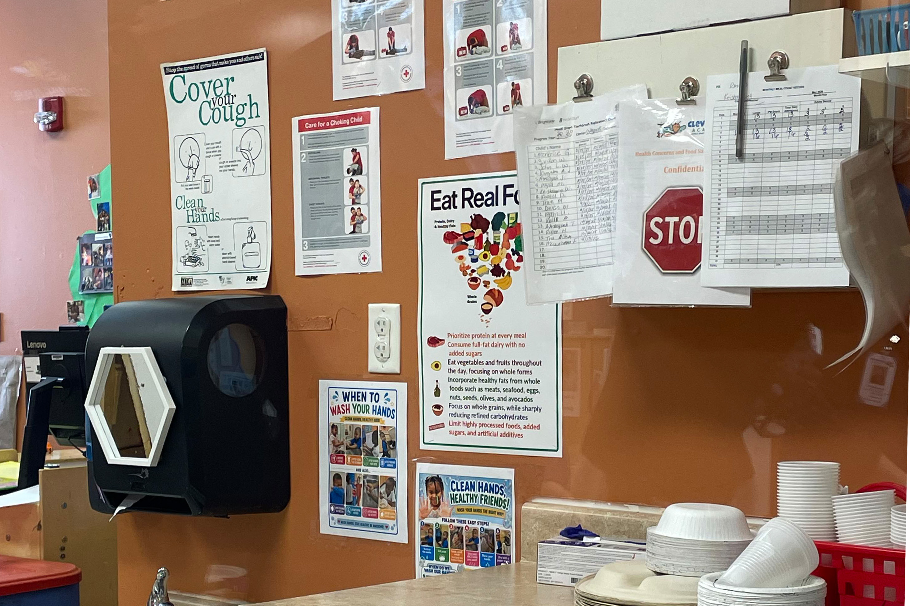 A wall of posters. One of the posters says "Eat real food" and shows the redesigned food pyramid.