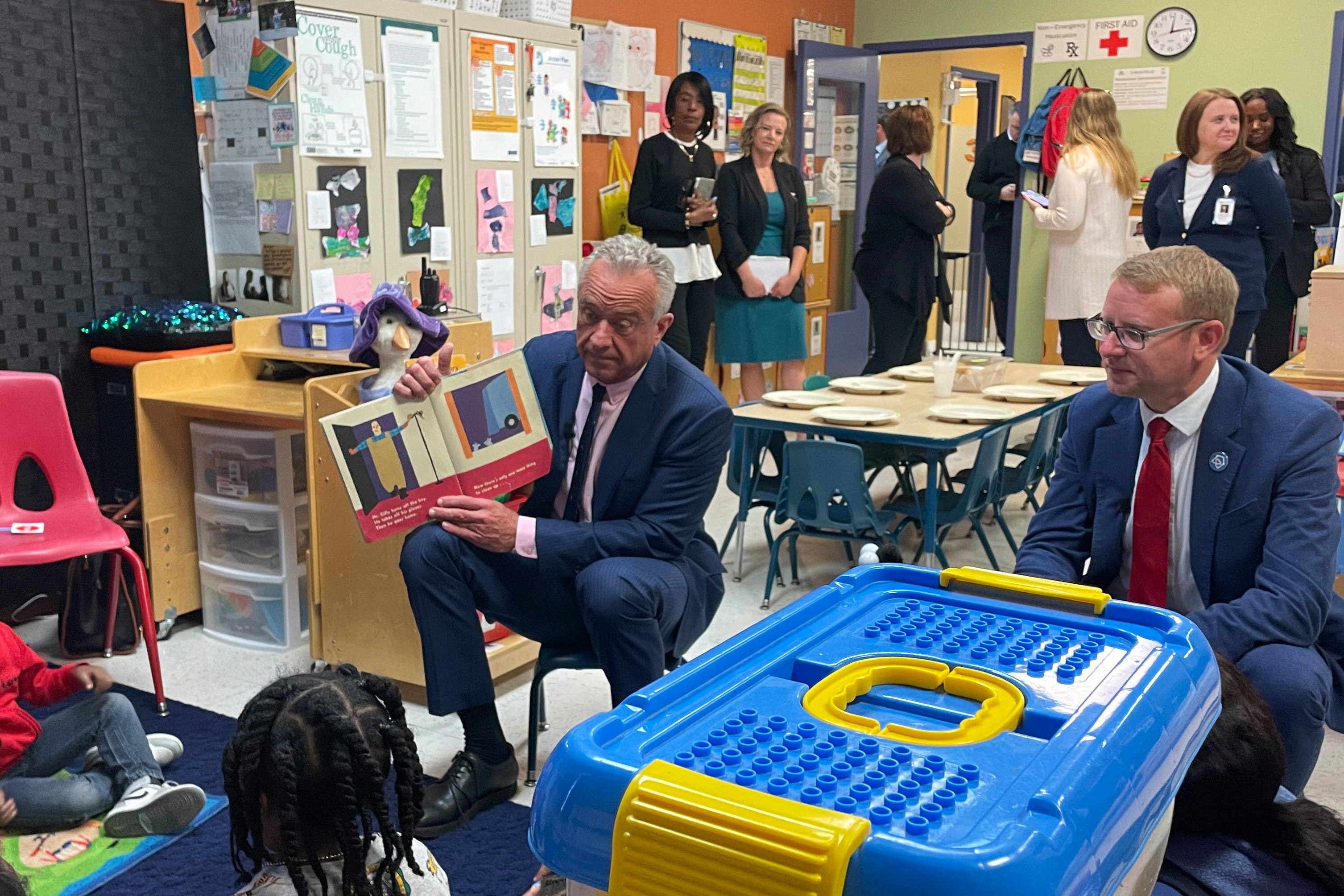 Robert F. Kennedy Jr. reads from a story book to children.