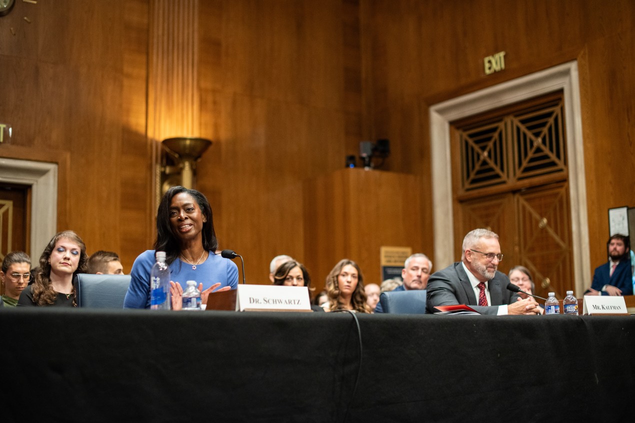 schwartz_03 A wide shot of a Senate hearing room. Erica Schwartz and Sean Kaufman sit next to each other at the witness table.
