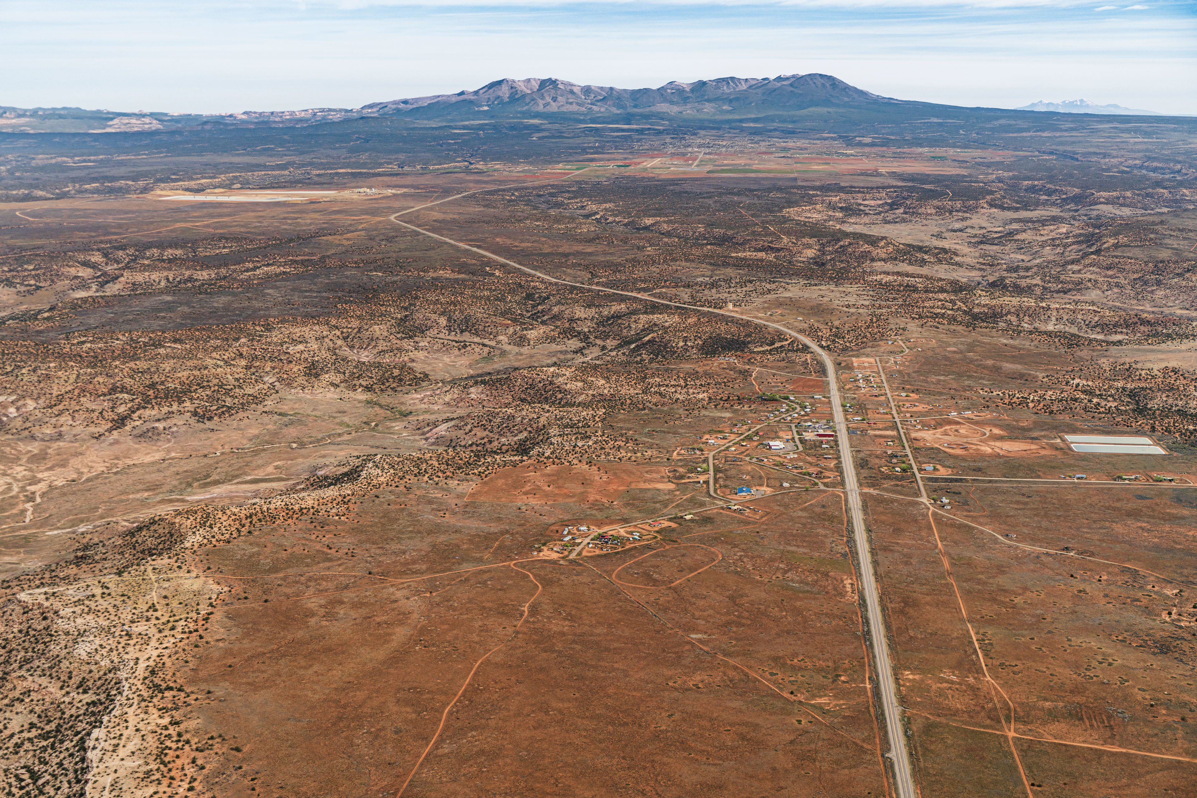 An aerial view of a desert community with mountains in the distance.